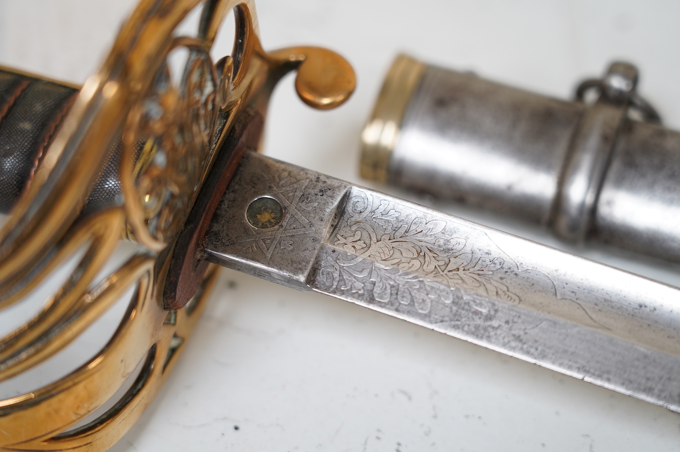 A Victorian 1845 pattern British Infantry Officer’s sword, by Hills Brothers of Old Bond Street, London, solid brass hilt in its steel dress scabbard, blade 81cm. Condition - fair, generally worn.